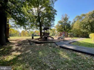 a view of a park with iron fence
