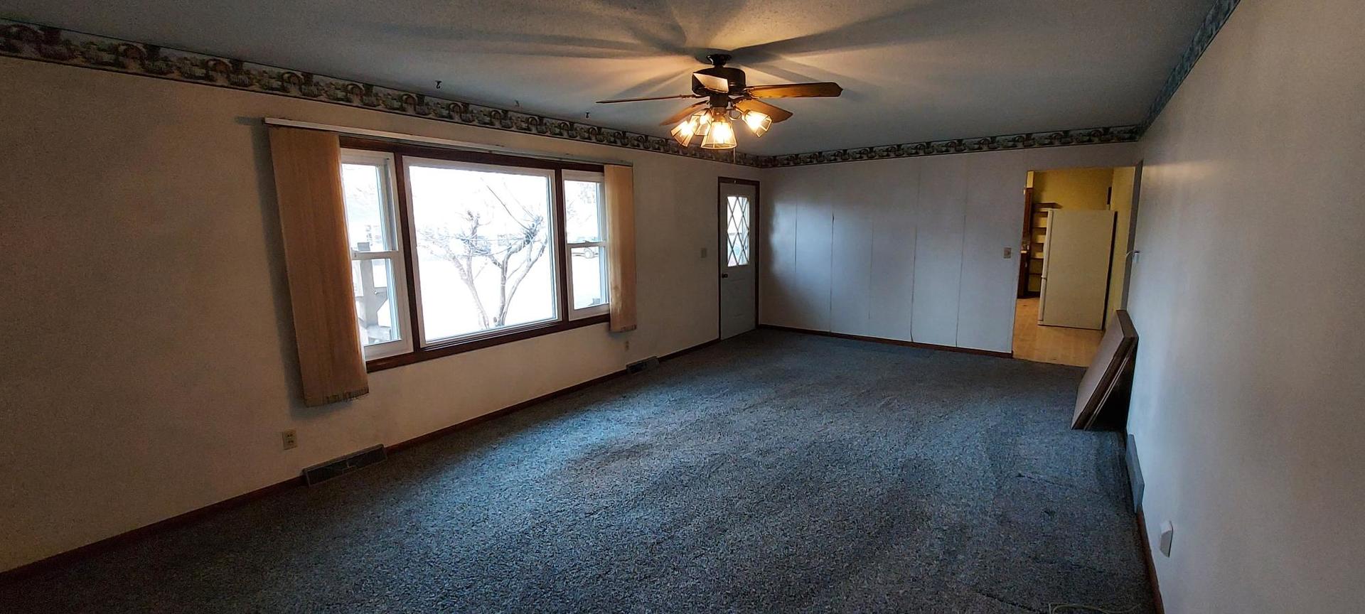 1606 20th Avenue Viola, IL 61486 - Photo 11 of 26 an empty room with windows and chandelier fan