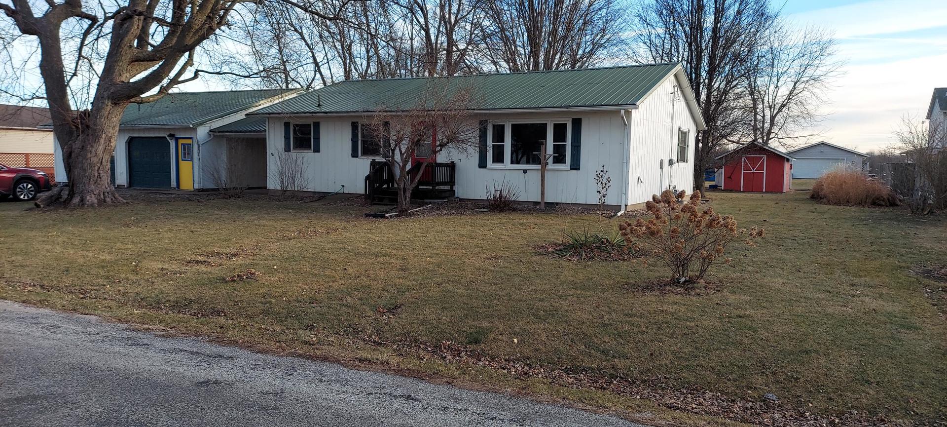 1606 20th Avenue Viola, IL 61486 - Photo 2 of 26 a view of a house with large tree and wooden fence