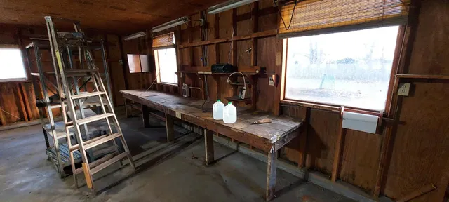 a view of a workspace with furniture and a window
