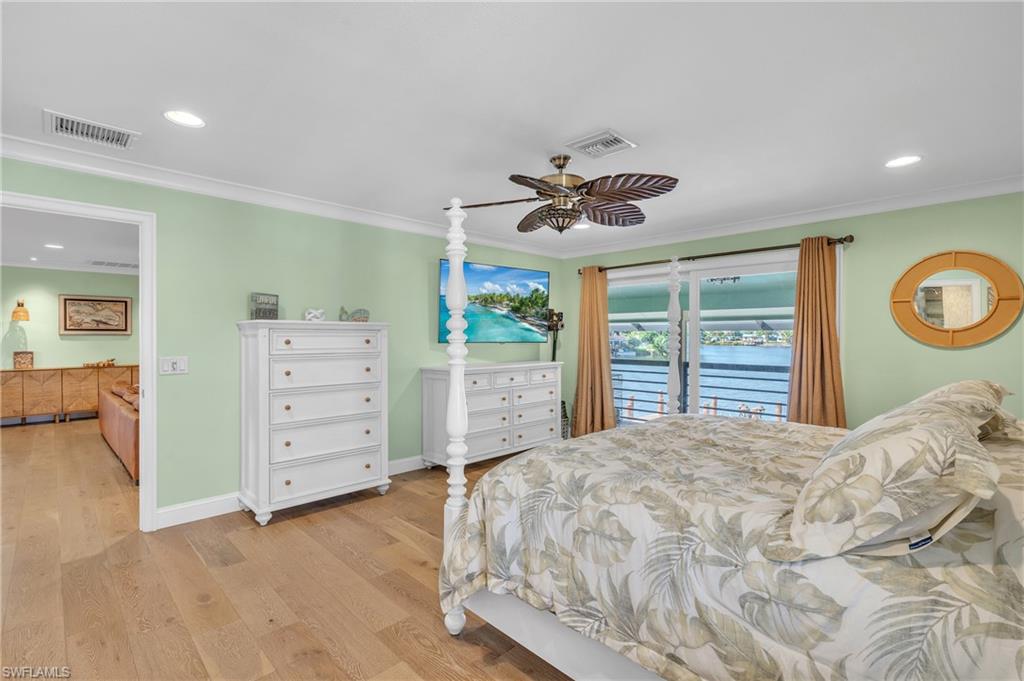 3001 50th Street Southwest Naples, FL 34116 - Photo 13 of 46 a bedroom with a large bed and a chandelier