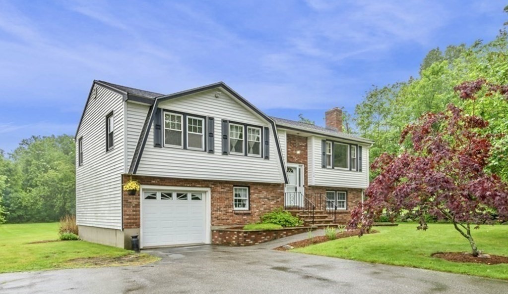 10 Wyman Road Billerica, MA 01821 - Photo 1 of 33 a front view of a house with a garden
