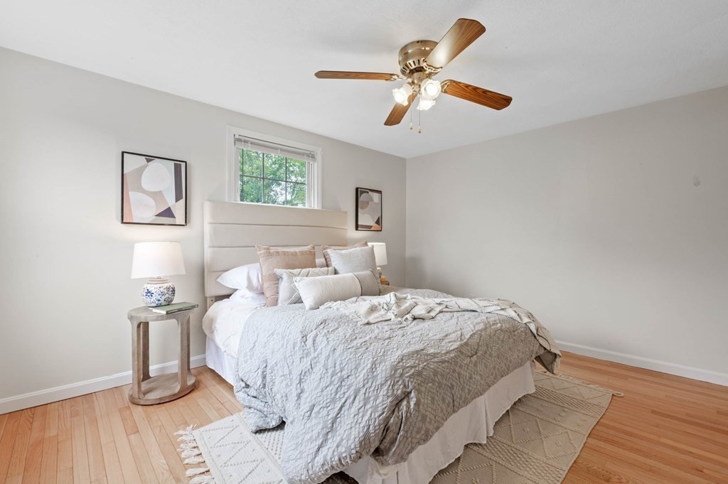 10 Wyman Road Billerica, MA 01821 - Photo 11 of 33 a bedroom with a bed and wooden floor