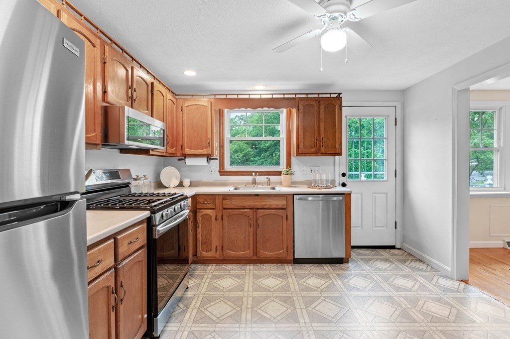 10 Wyman Road Billerica, MA 01821 - Photo 10 of 33 a kitchen with a stove a sink and a refrigerator