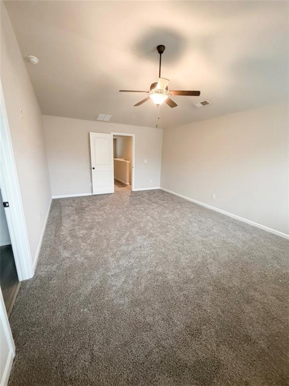 11644 Stovall Place Hampton, GA 30228 - Photo 18 of 18 an empty room with chandelier fan and windows