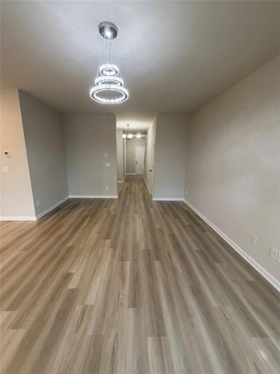 11644 Stovall Place Hampton, GA 30228 - Photo 6 of 18 a view of an empty room with wooden floor and a window