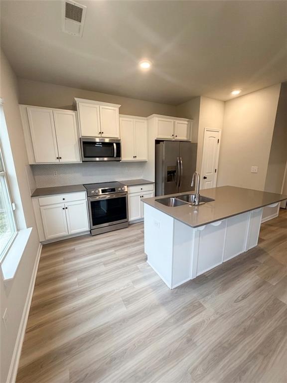 11644 Stovall Place Hampton, GA 30228 - Photo 7 of 18 a large kitchen with kitchen island a sink dishwasher stove with cabinets and wooden floor