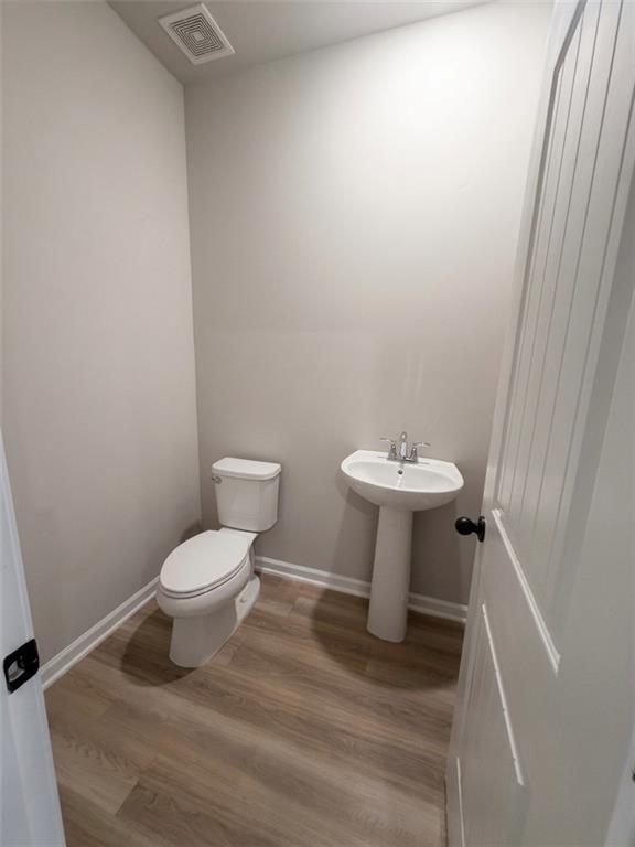 11644 Stovall Place Hampton, GA 30228 - Photo 8 of 18 a bathroom with a sink toilet and a mirror