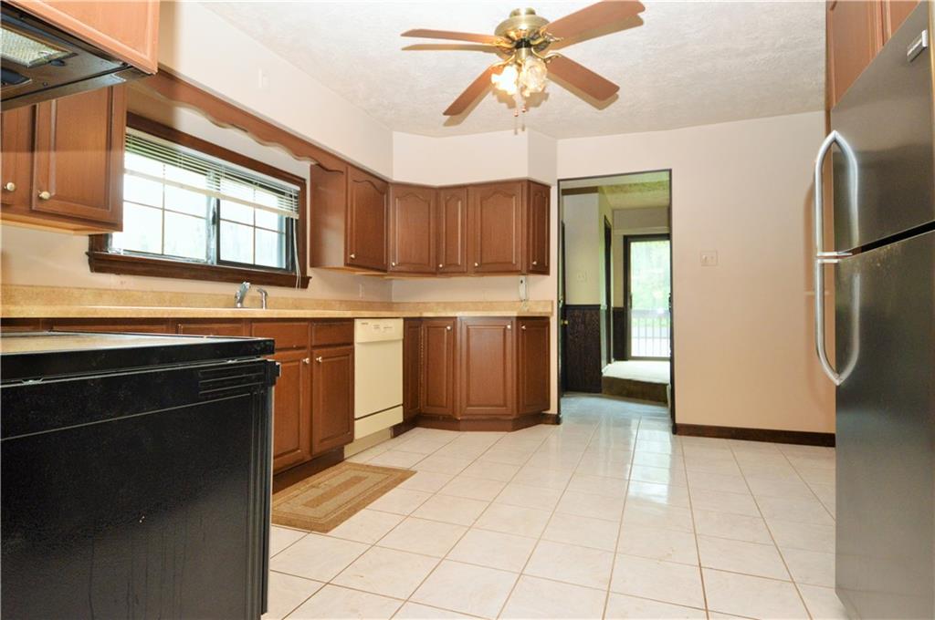 1019-1021 Moon Run Road McKees Rocks, PA 15136 - Photo 3 of 23 a kitchen with stainless steel appliances granite countertop a refrigerator a sink and dishwasher