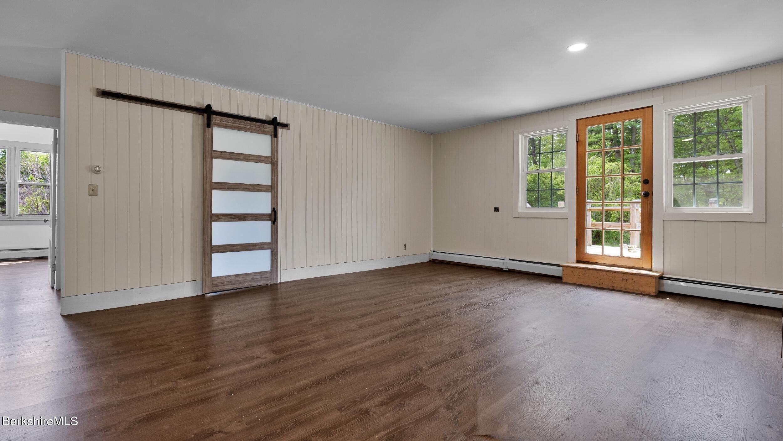 20 East Dugway Road Lenox, MA 01240 - Photo 36 of 84 an empty room with wooden floor and windows