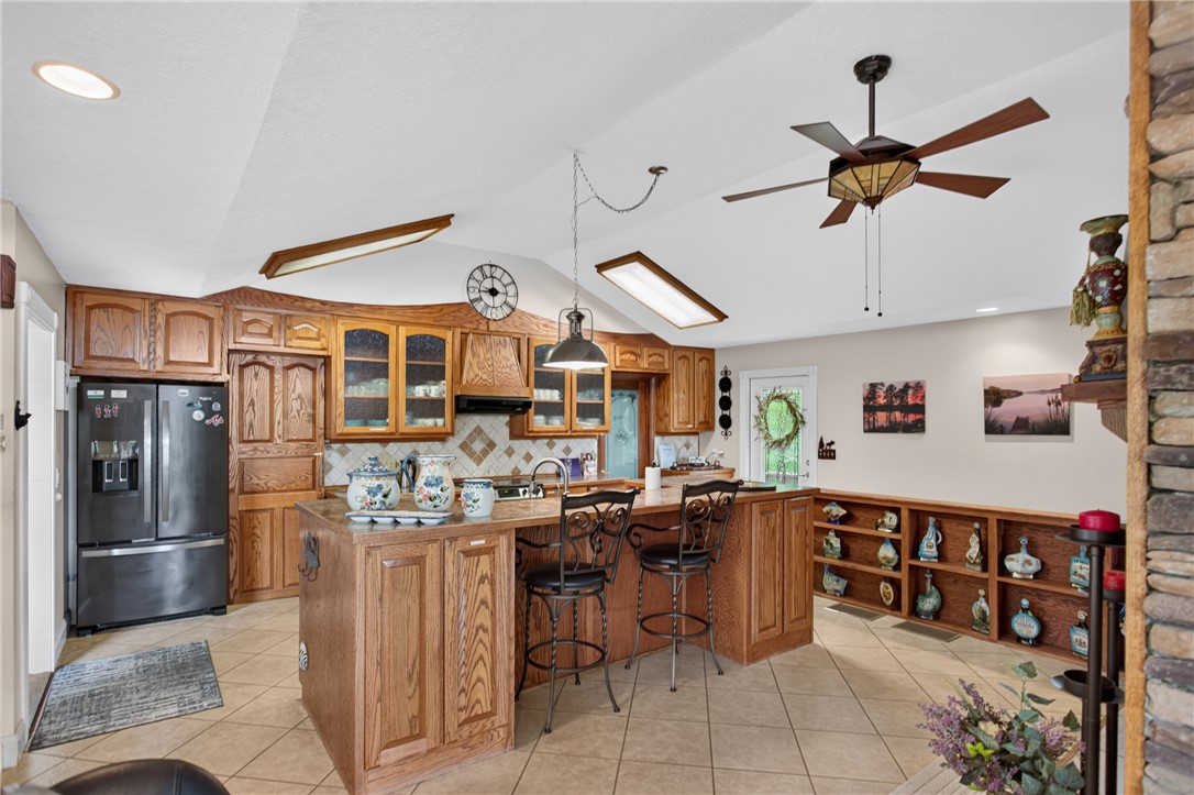 351 River Road Westminster, SC 29693 - Photo 8 of 50 A well-equipped kitchen features a central island, ample wood cabinetry, and a vaulted ceiling.