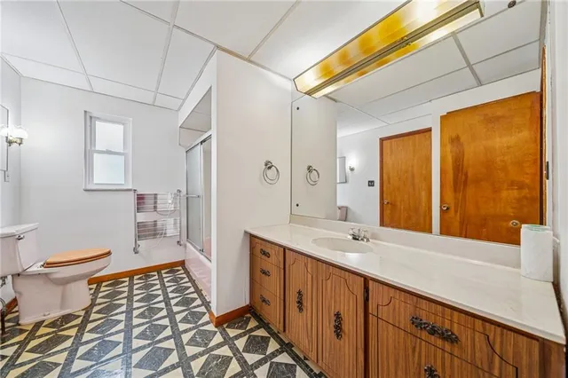 a spacious bathroom with a double vanity sink toilet and a tub