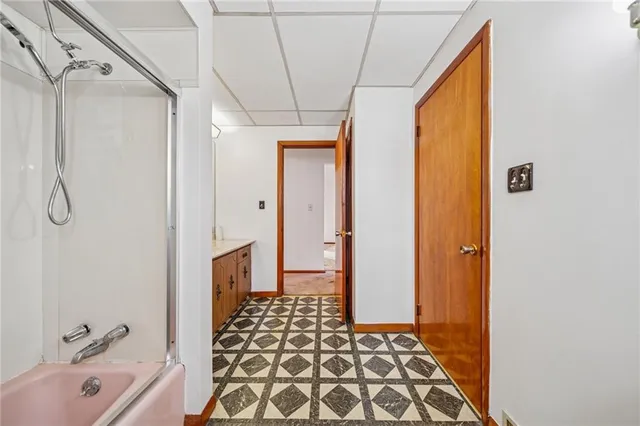 a bathroom with a bathtub and a shower