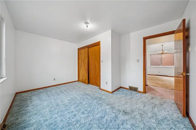 an empty room with closet area