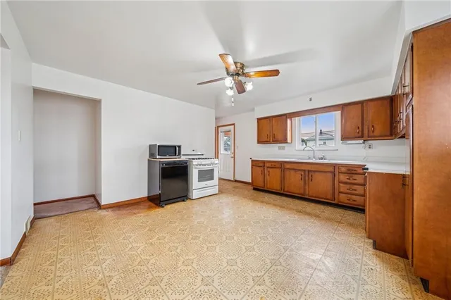 a view of a kitchen with a sink and a refrigerator