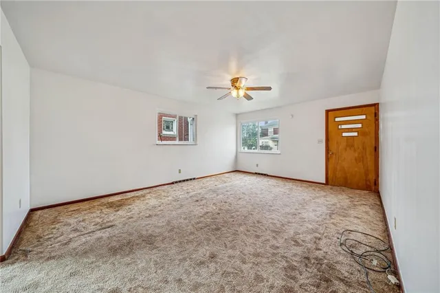 a view of an empty room and a window