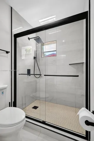 a bathroom with a shower and a toilet