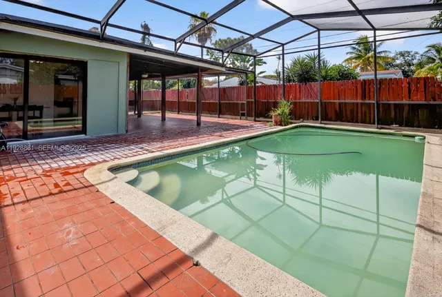 a view of a backyard with a table and chairs