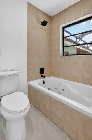 a bathroom with a toilet a sink and bathtub