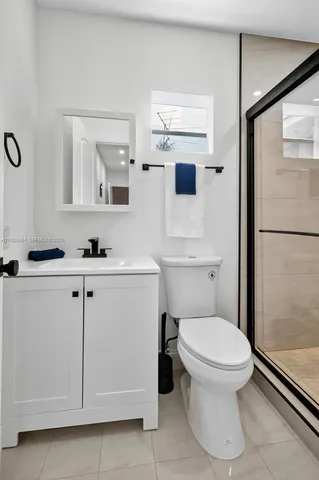 a white toilet sitting next to a bathroom sink