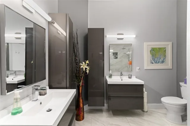 a bathroom with a sink toilet and shower