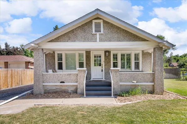 a front view of a house with a yard outdoor seating and garage
