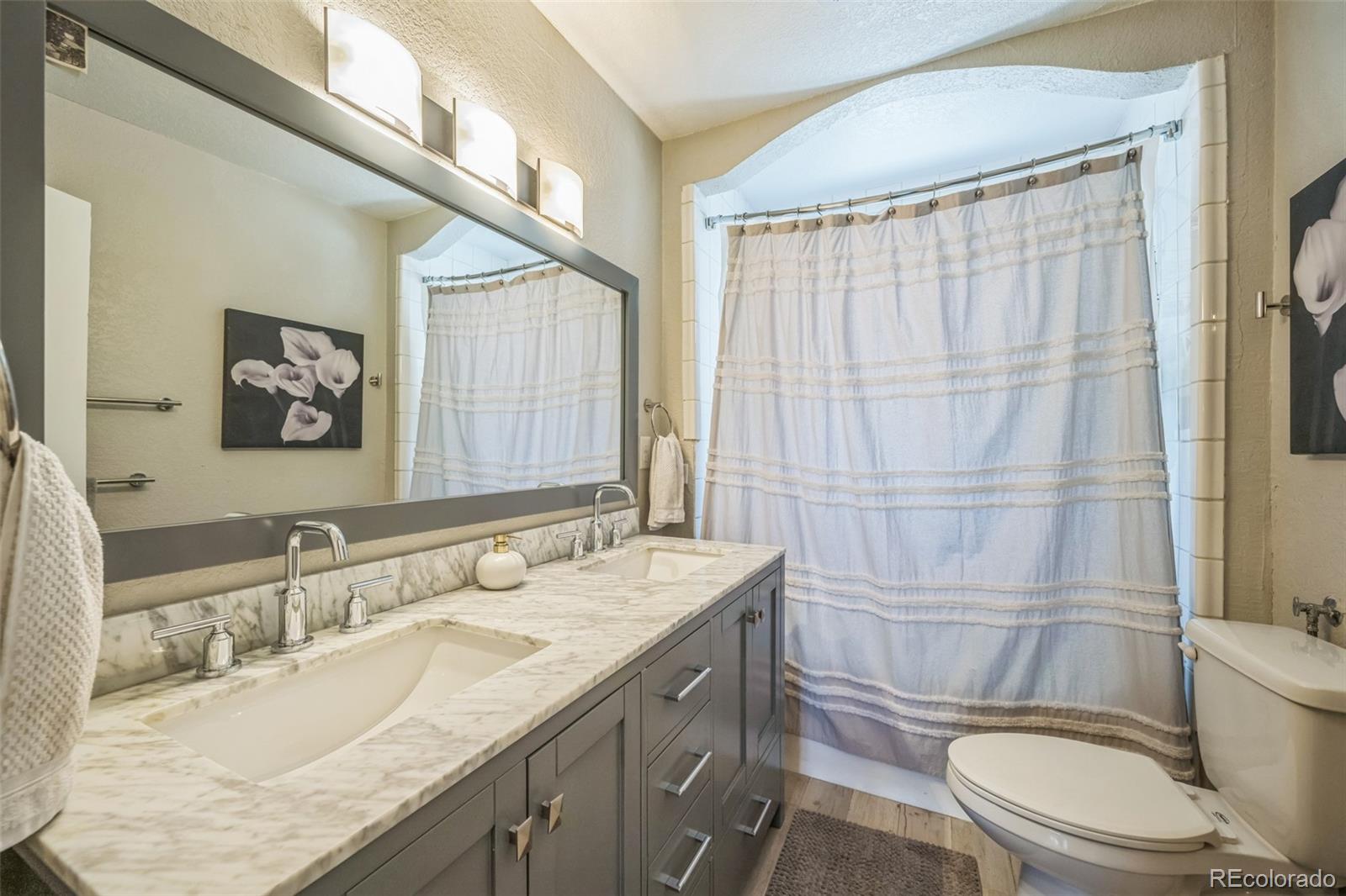 7340 West 32nd Avenue Wheat Ridge, CO 80033 - Photo 14 of 35 a bathroom with a granite countertop toilet sink and mirror