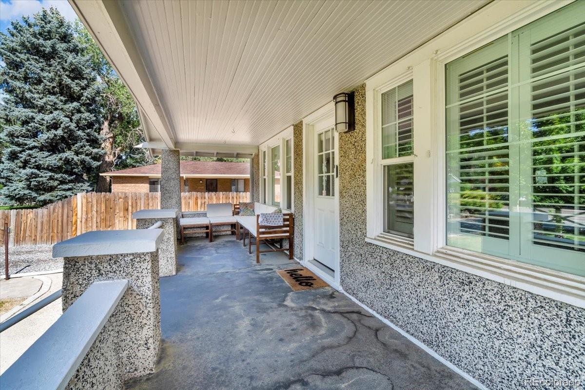 7340 West 32nd Avenue Wheat Ridge, CO 80033 - Photo 2 of 35 a backyard of a house with barbeque oven table and chairs