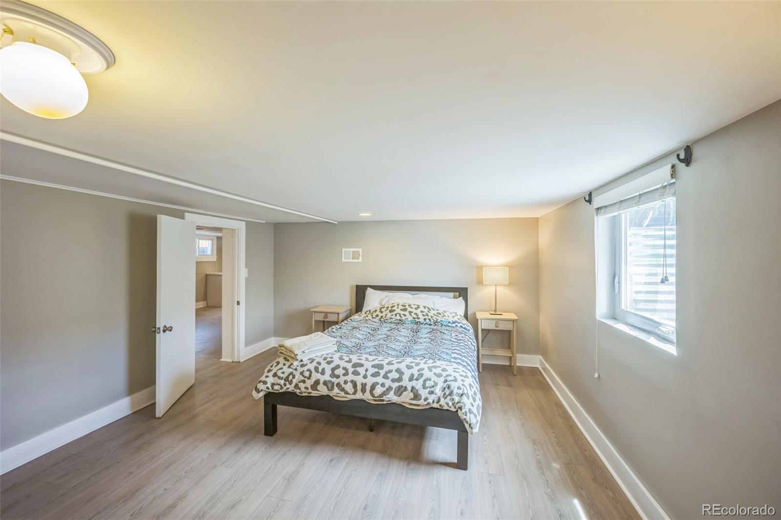 7340 West 32nd Avenue Wheat Ridge, CO 80033 - Photo 22 of 35 a bedroom with a bed and window