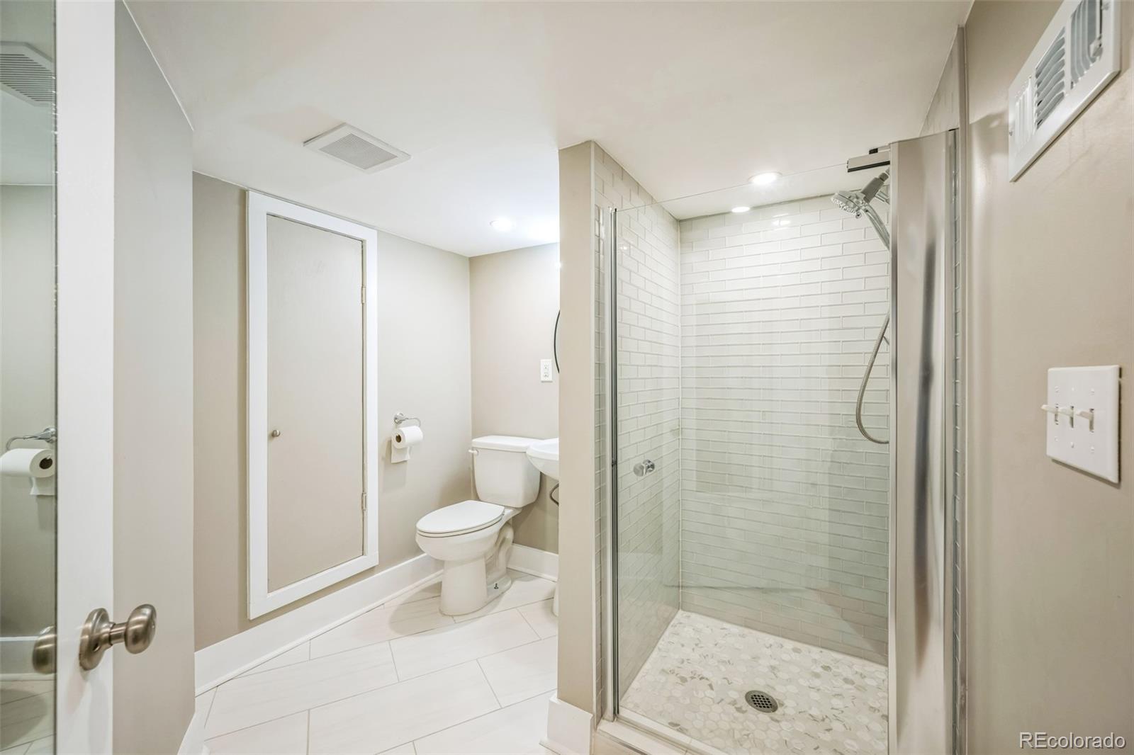 7340 West 32nd Avenue Wheat Ridge, CO 80033 - Photo 23 of 35 a bathroom with a shower and a toilet