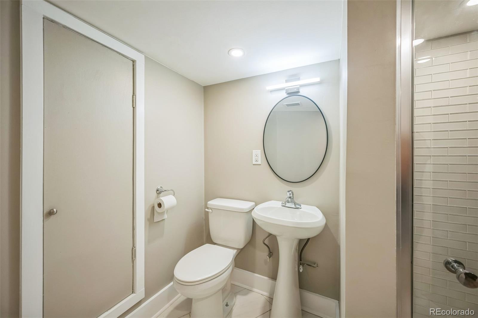 7340 West 32nd Avenue Wheat Ridge, CO 80033 - Photo 24 of 35 a bathroom with a toilet sink and a mirror