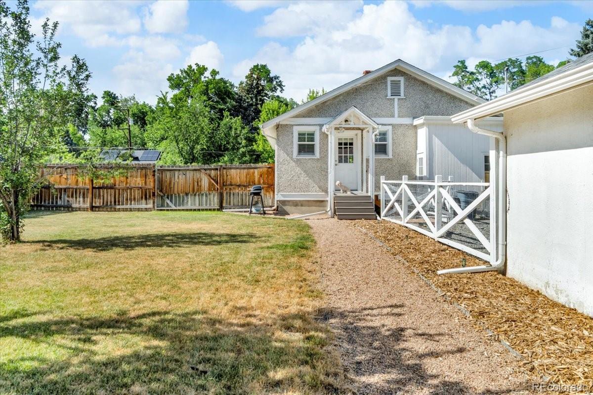 7340 West 32nd Avenue Wheat Ridge, CO 80033 - Photo 26 of 35 a view of a house with a yard