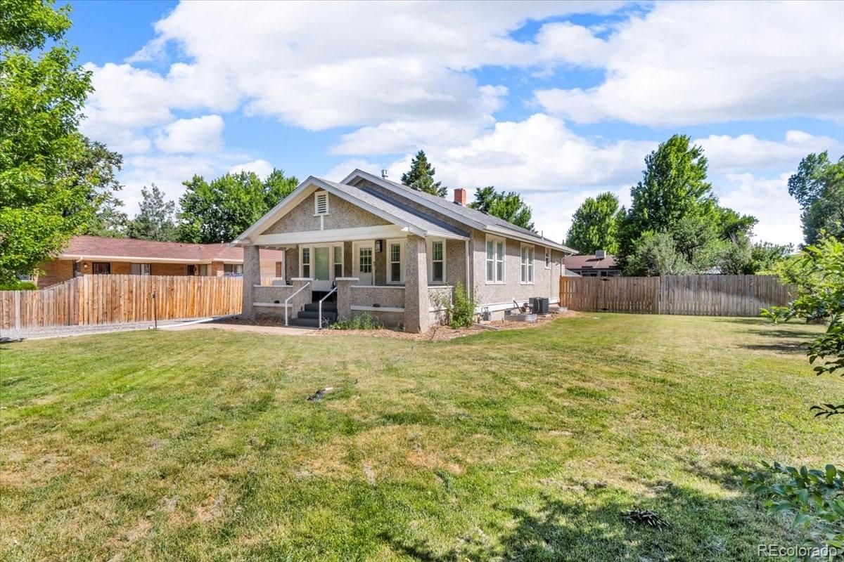 7340 West 32nd Avenue Wheat Ridge, CO 80033 - Photo 34 of 35 a front view of a house with garden