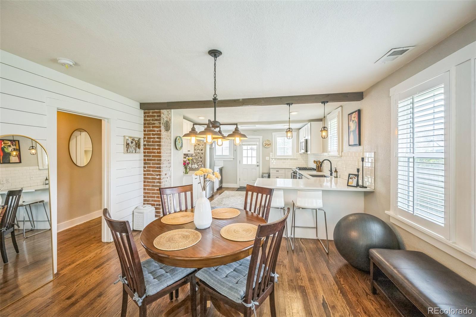 7340 West 32nd Avenue Wheat Ridge, CO 80033 - Photo 5 of 35 a view of a dining room with furniture window and wooden floor