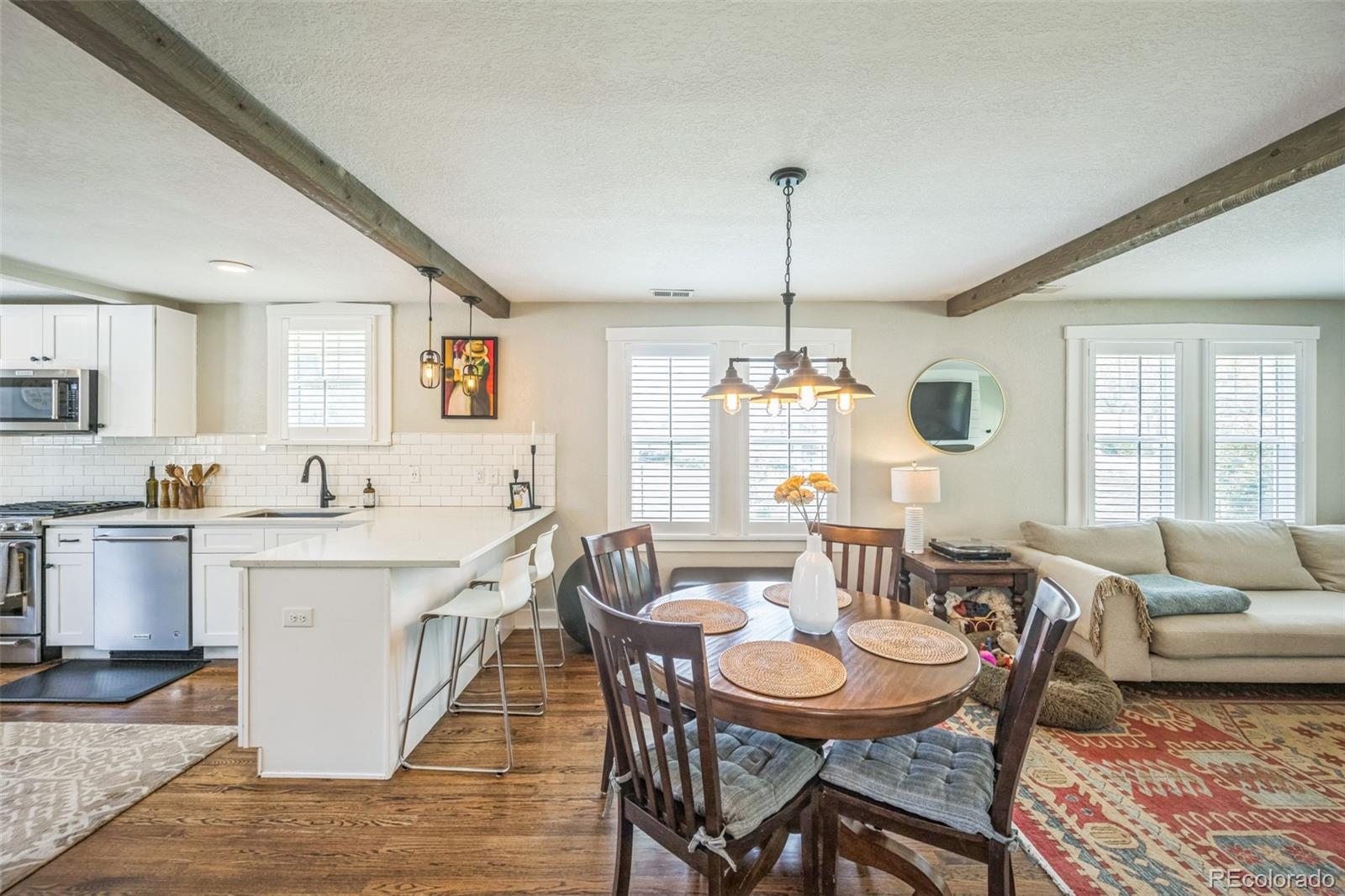 7340 West 32nd Avenue Wheat Ridge, CO 80033 - Photo 6 of 35 a large kitchen with a table and chairs