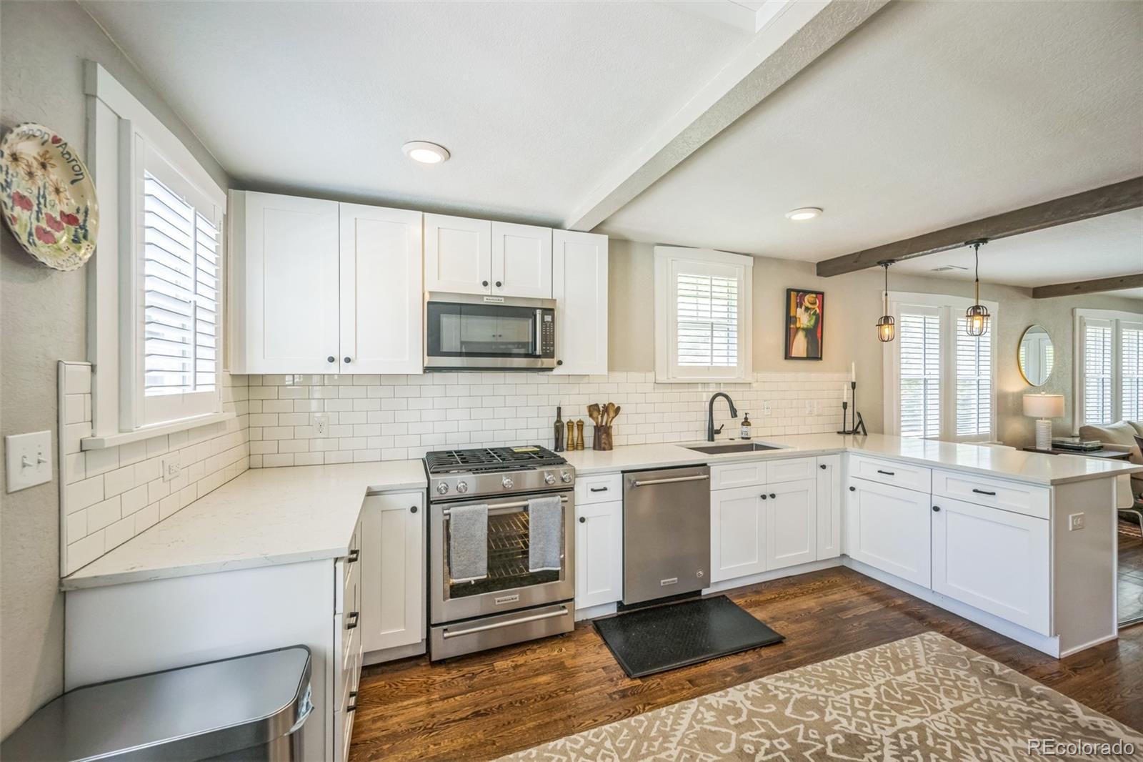 7340 West 32nd Avenue Wheat Ridge, CO 80033 - Photo 8 of 35 a kitchen with a sink stove and cabinets