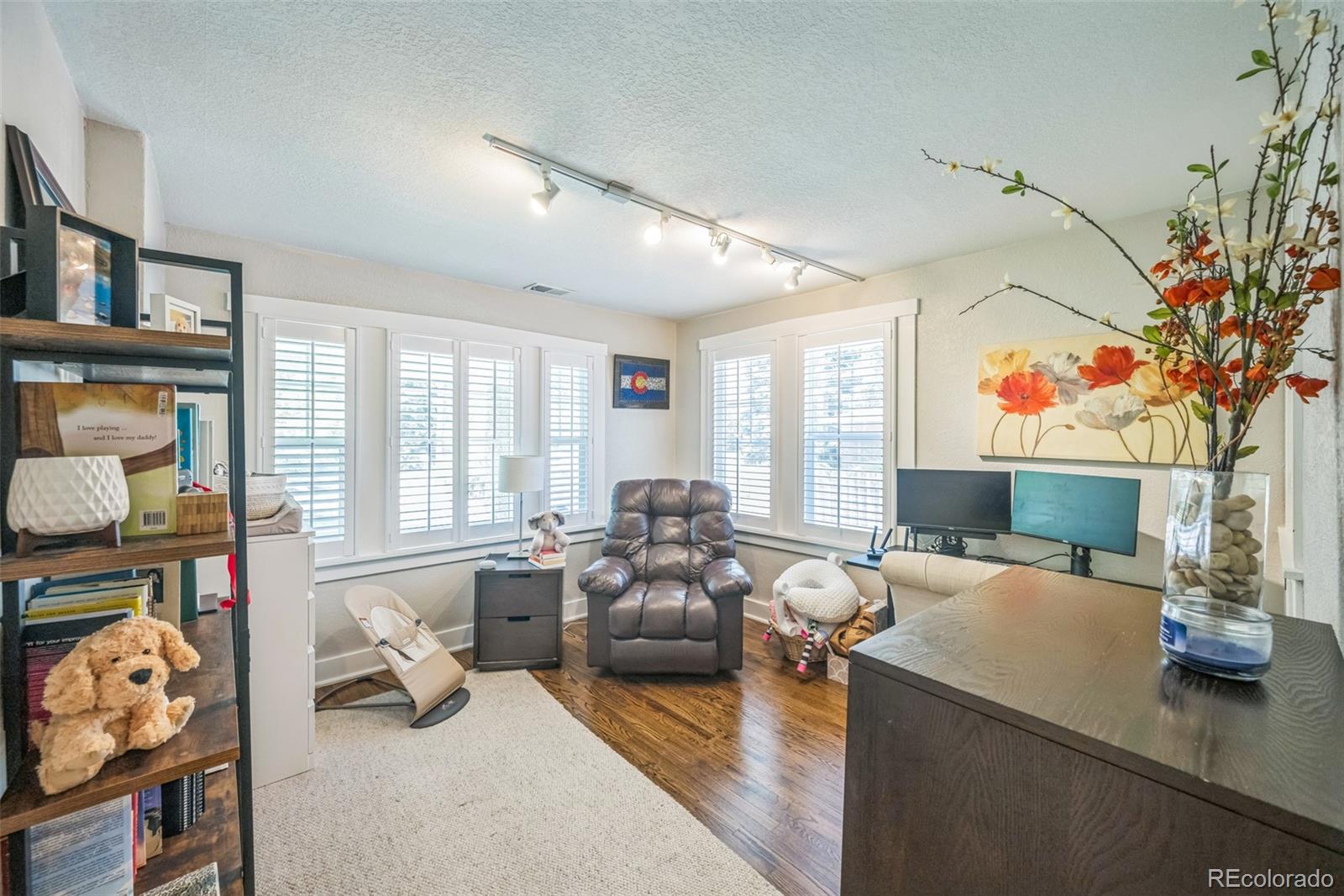 7340 West 32nd Avenue Wheat Ridge, CO 80033 - Photo 10 of 35 a living room with furniture and a flat screen tv
