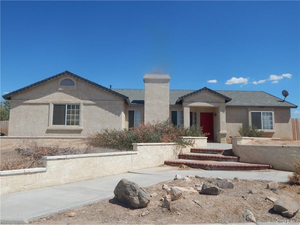 14367 Pioneer Road Apple Valley, CA 92307 - Photo 1 of 1 a front view of a house with a yard