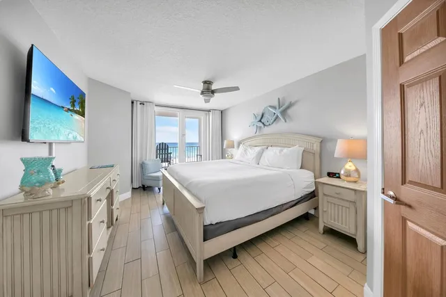 a bedroom with a bed and a flat screen tv