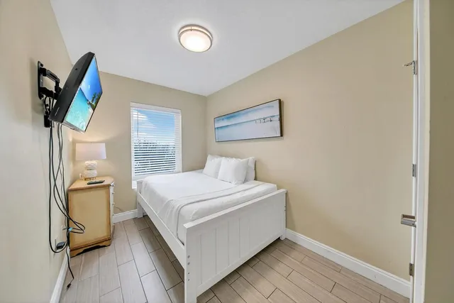 a bedroom with a bed and a painting on the wall