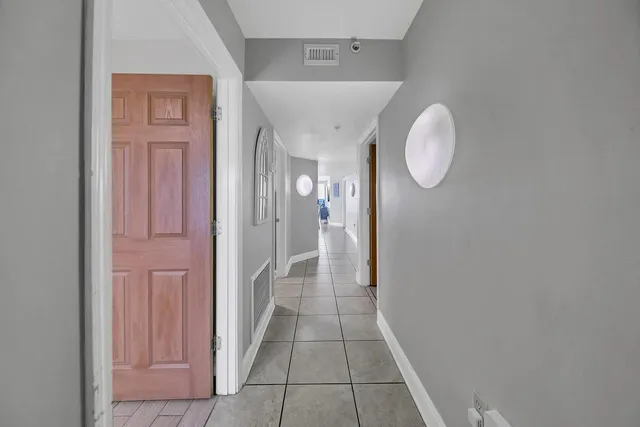 a view of a hallway and wooden floor