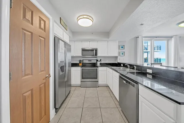 a large kitchen with cabinets and stainless steel appliances