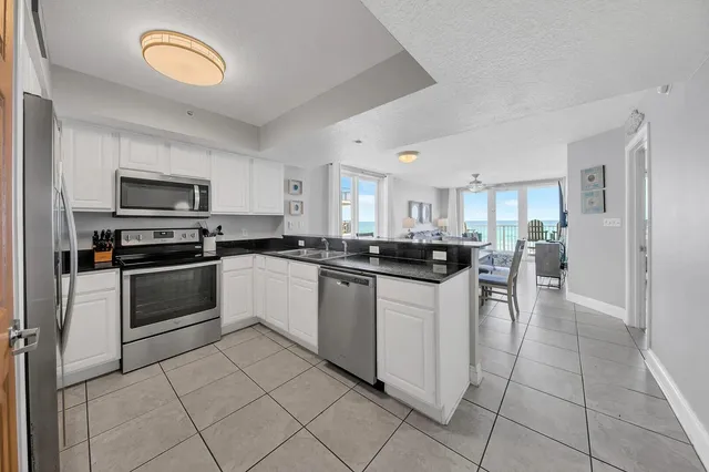 a kitchen with granite countertop cabinets and steel stainless steel appliances