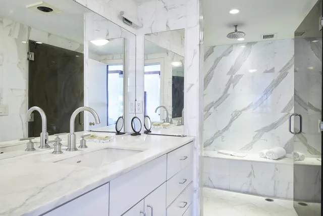 a bathroom with double vanity sinks and a mirror
