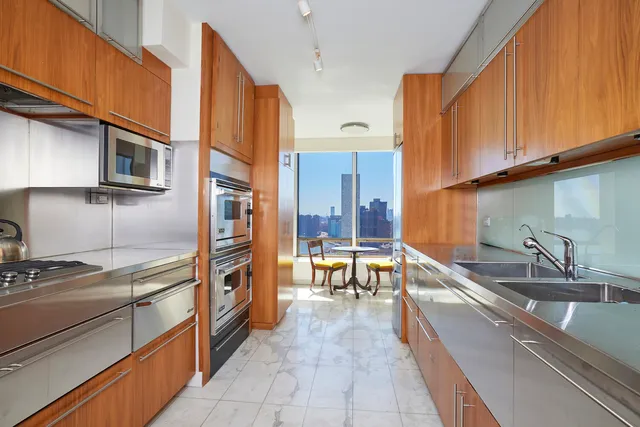a kitchen with stainless steel appliances granite countertop a sink stove and cabinets