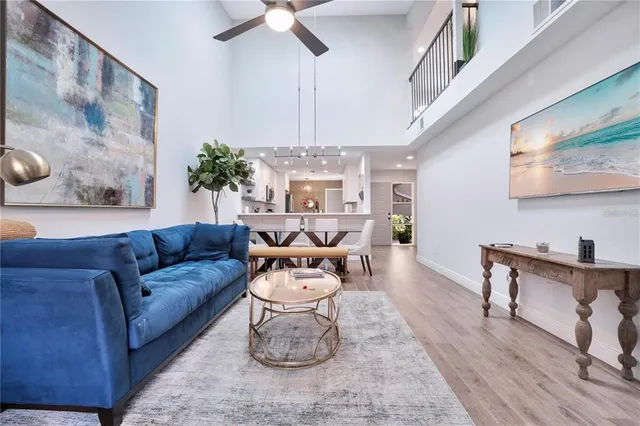 a living room with furniture and a chandelier
