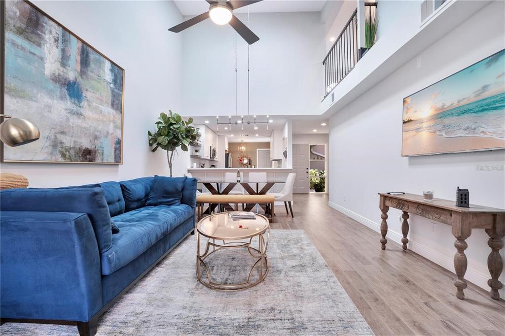 7736 Windbreak Road Orlando, FL 32819 - Photo 11 of 43 a living room with furniture and a chandelier