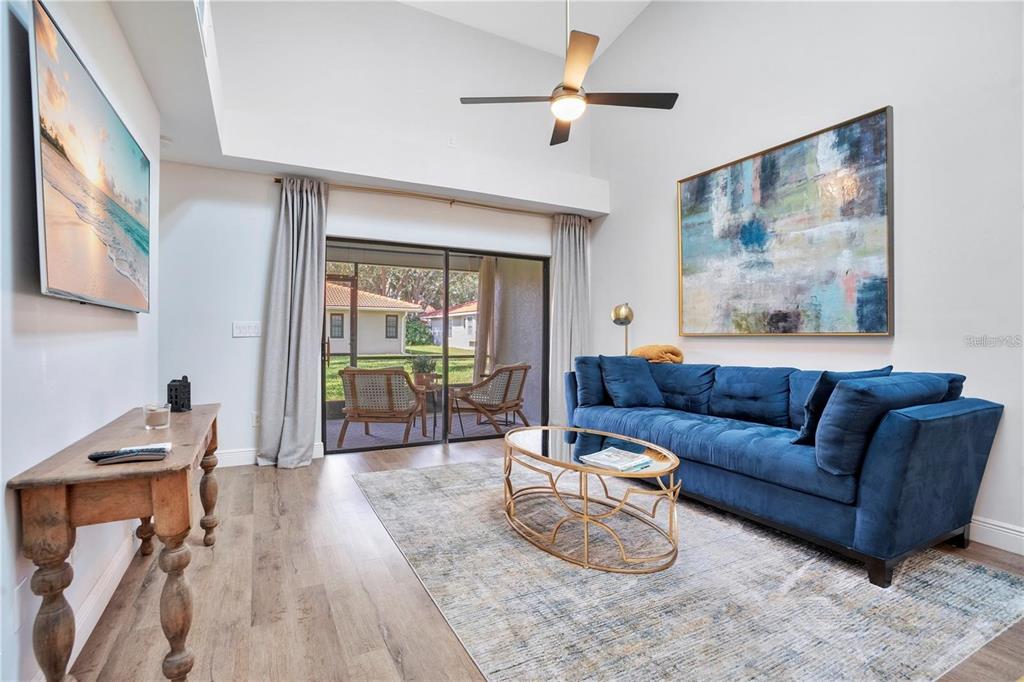 7736 Windbreak Road Orlando, FL 32819 - Photo 12 of 43 a living room with furniture and a large window