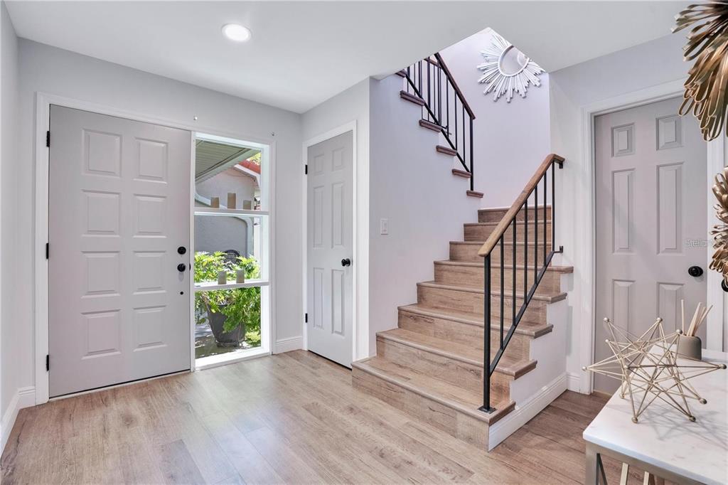 7736 Windbreak Road Orlando, FL 32819 - Photo 16 of 43 a view of entryway with wooden floor
