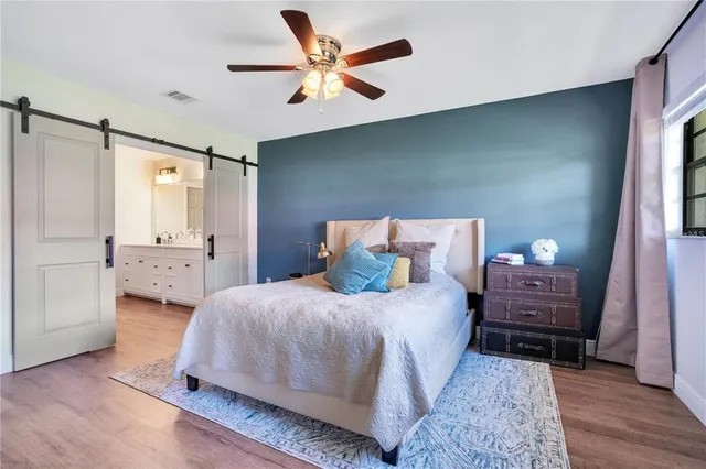 a bedroom with a bed and a chandelier